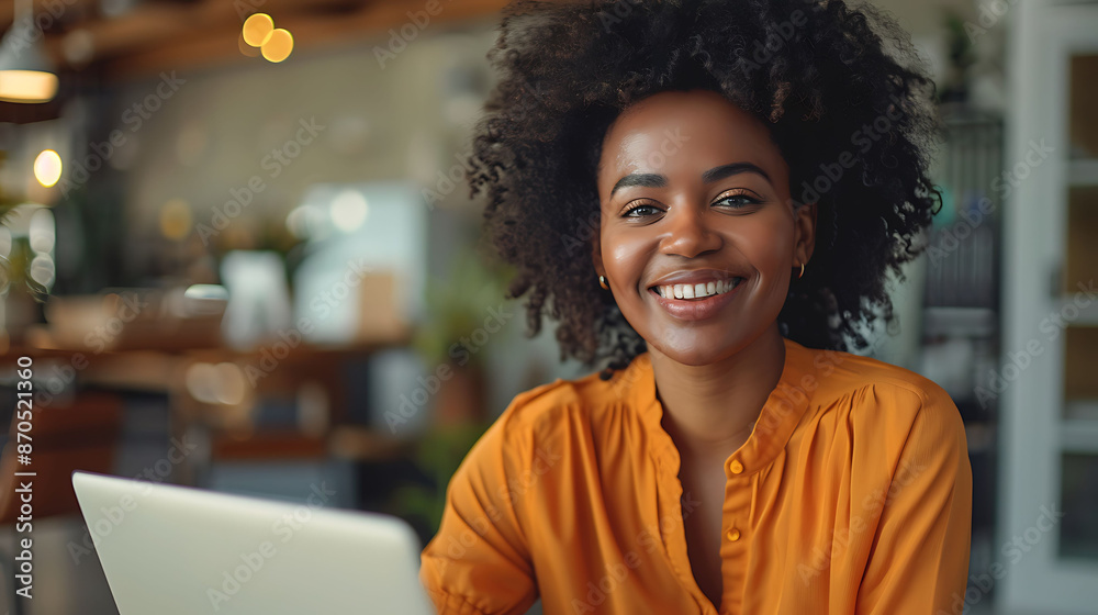 Fototapeta premium Smiling Woman Using Laptop in Cafe With Plants