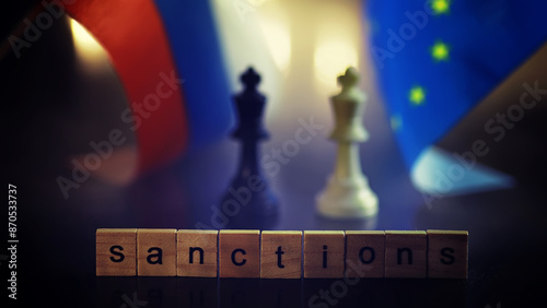 word sanctions spelled in letters on table made of wooden block letters with dramatic lighting and smoke photo