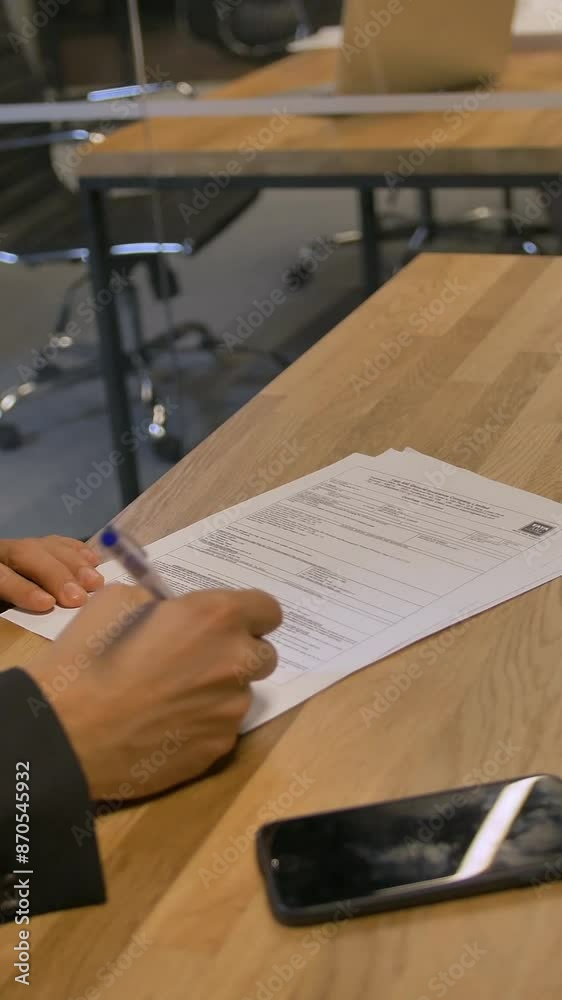 Customer signing employment contract in office during the meeting. They have serious discussion in boardroom and signing of important documents. 4k Slow motion. Vertical shot. Customer signing employment contract in office during the meeting. They have serious discussion in boardroom and signing of important documents. 4k Slow motion. Vertical shot.