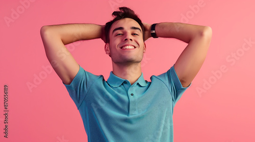 A joyful millennial man in a polo shirt, confidently posing and smiling against a solid pink background