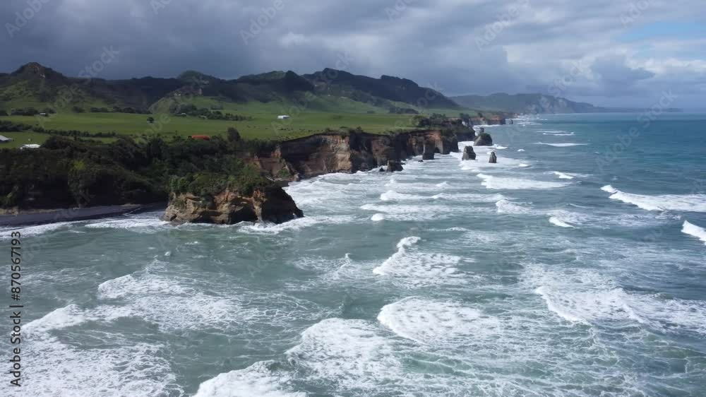 Drone view of the coast, rocks and ocean on a sunny summer day at Three Sisters and Elephant Rock, New Zealand. Drone view of the coast, rocks and ocean on a sunny summer day at Three Sisters and Elephant Rock, New Zealand.