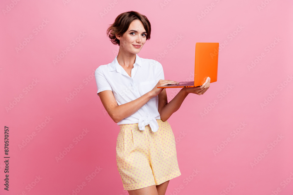 Photo of attractive nice young woman wearing summer glamour outfit using new pc laptop to check emails isolated on pink color background Photo of attractive nice young woman wearing summer glamour outfit using new pc laptop to check emails isolated on pink color background