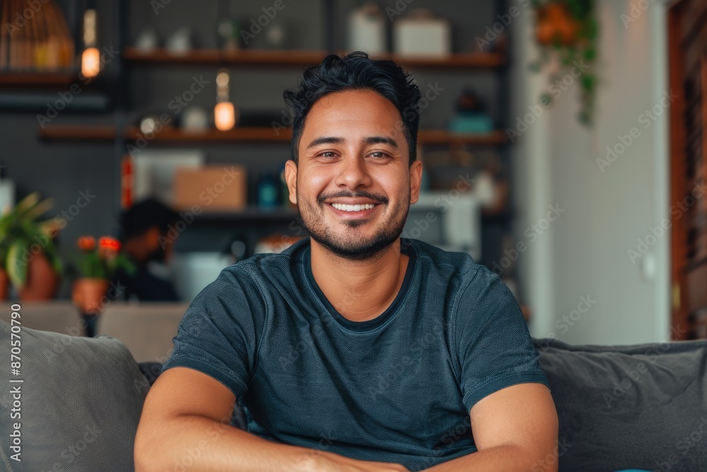 Obraz premium Happy mid adult man relaxing at home smiling on sofa.