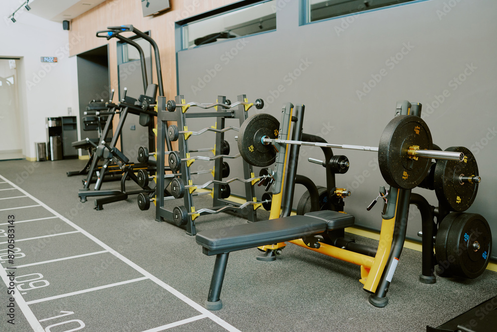 Obraz premium Spacious modern zone for pumping iron, zone equipped with bars plates bench