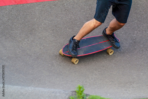 Close-Up of Skater on Longboard Making a Turn on Asphalt Track photo