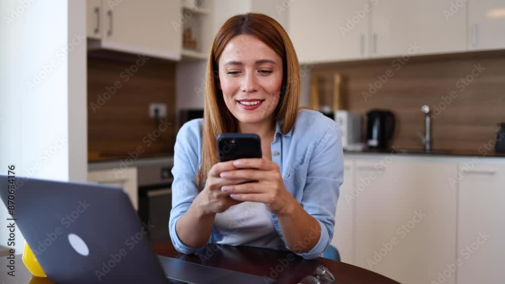 Young woman using laptop and smartphone at home Young woman using laptop and smartphone at home