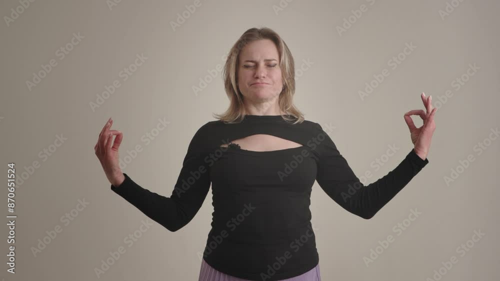A woman in meditation pose with raised hands, seeking relaxation and calmness in her mind and body A woman in meditation pose with raised hands, seeking relaxation and calmness in her mind and body