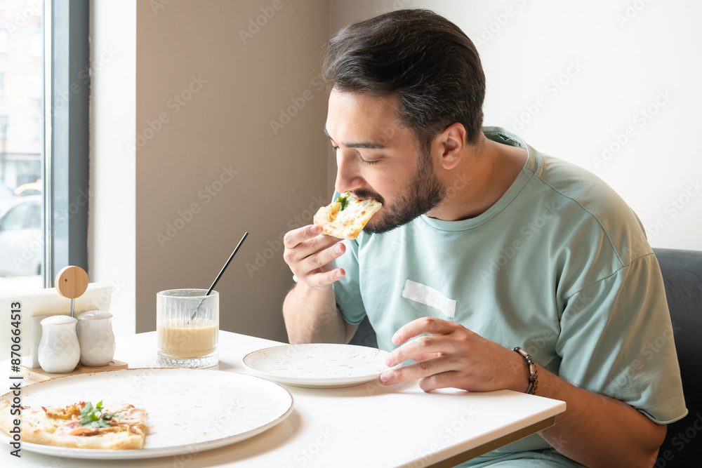 Hungry man eats delicious pizza at the cafe Hungry man eats delicious pizza at the cafe