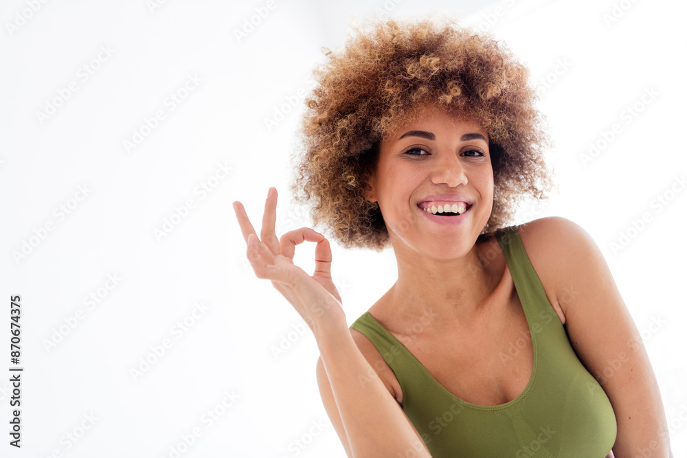 Unretouched portrait of body positive girl make okay symbol isolated light color background Unretouched portrait of body positive girl make okay symbol isolated light color background