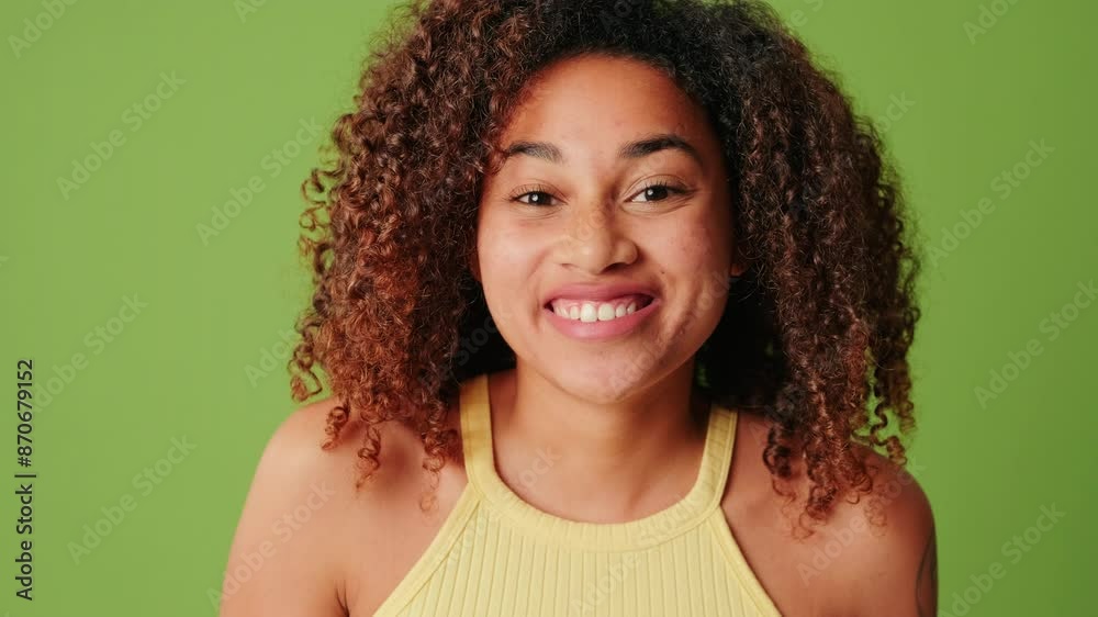 Close-up of a surprised girl on a green screen background, touches her mouth in amazement Close-up of a surprised girl on a green screen background, touches her mouth in amazement