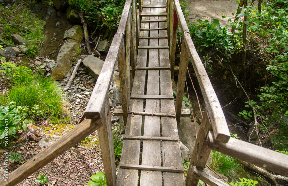 Wooden bridge over a mountain river Wooden bridge over a mountain river