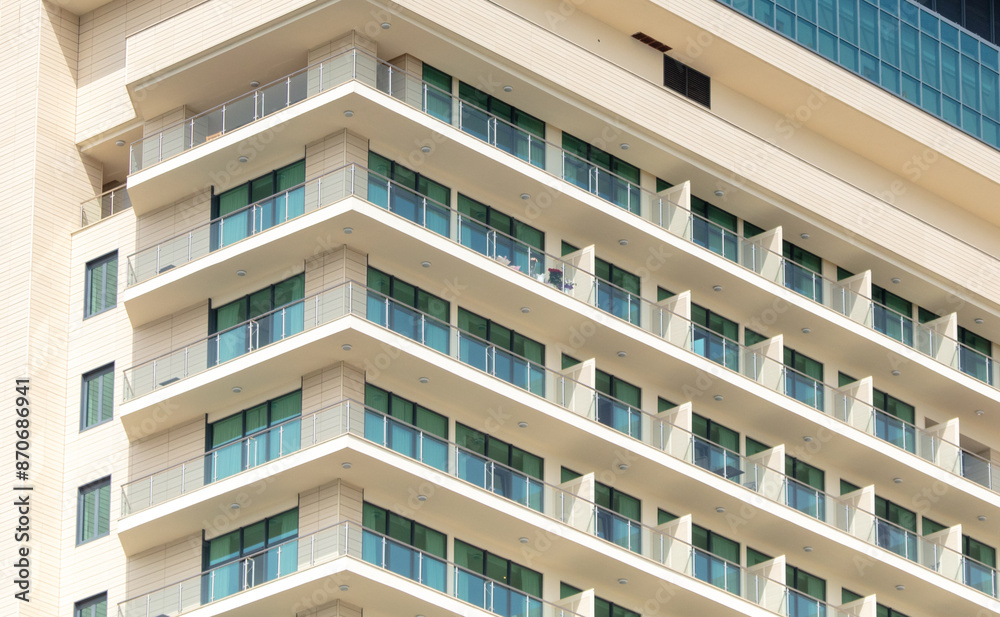 Fototapeta premium Multi-storey building with windows as background. Text