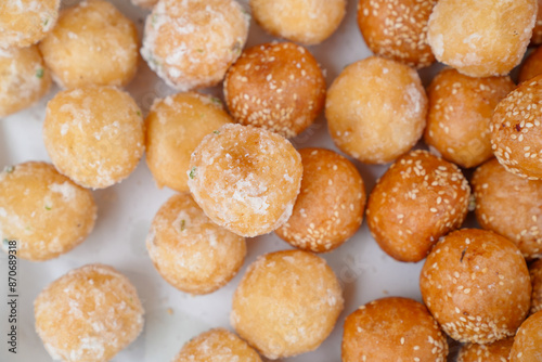 Thai traditional dessert. Deep fried sesame balls and deep fried sweet potato balls on stainless steel tray of seller.
