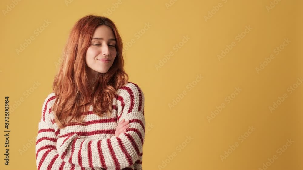 Girl looking away to show mockup space on yellow background in studio Girl looking away to show mockup space on yellow background in studio
