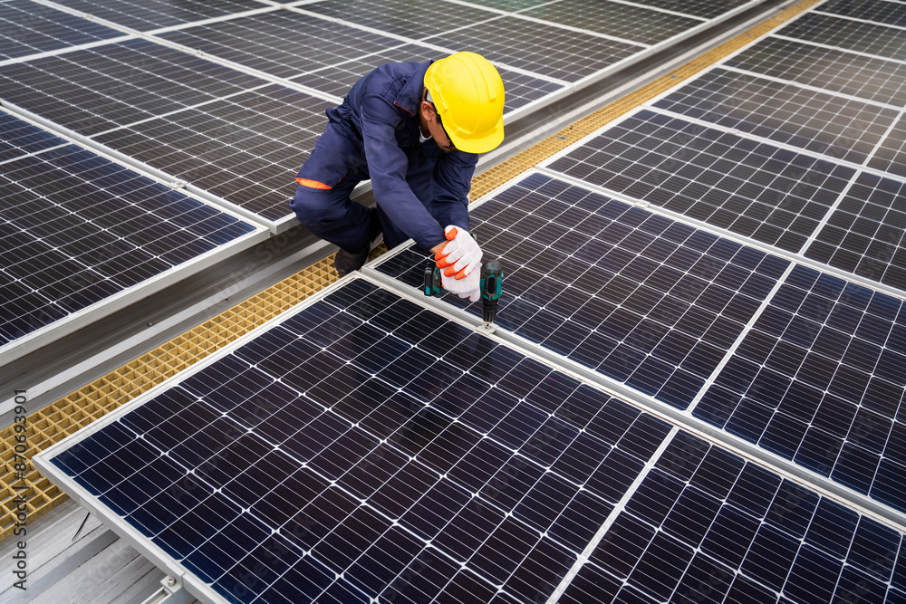 A technician inspects or maintain solar panels on a modern rooftop. A technician inspects or maintain solar panels on a modern rooftop.