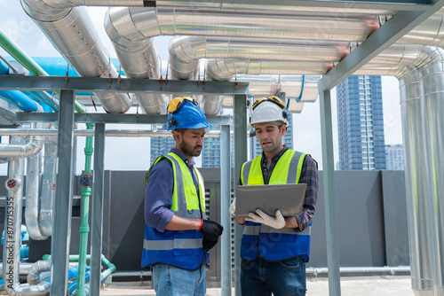 Engineer under checking the industry chilled water fan coil unit air conditioner is water cooling tower air chiller HVAC system of large industrial building to control air system