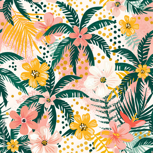 A vibrant summer seamless pattern. Tropical flowers and palm leaves. Polka dot background. Hawaiian print. 