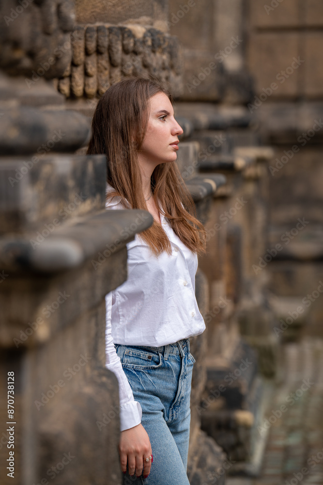 Portrait of a girl in a white blouse near a stone wall. Sweet young woman visits new places, travels. Portrait of a girl in a white blouse near a stone wall. Sweet young woman visits new places, travels.