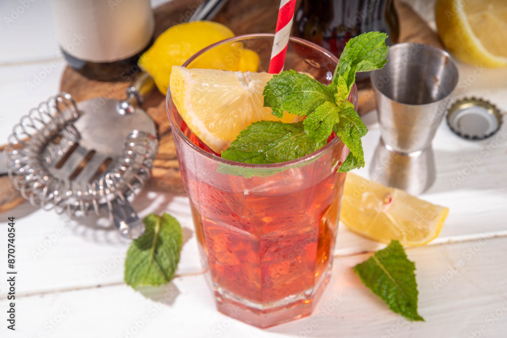 Fototapeta premium Cola and wine sweet sour alcoholic drink, Kalimotxo or calimocho boozy fizzy cocktail with ice cubes, lemon and mint, copy space