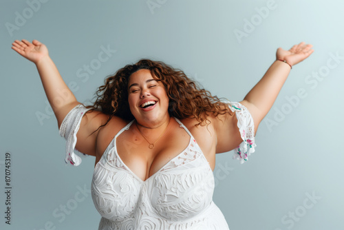 Happy plus size model on gray background, fat woman with chubby face, body positive concept photo