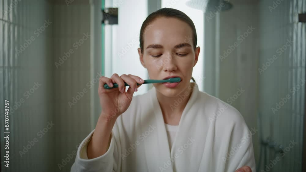 Closeup girl toothbrushing morning at home. Pretty woman getting ready to work Closeup girl toothbrushing morning at home. Pretty woman getting ready to work