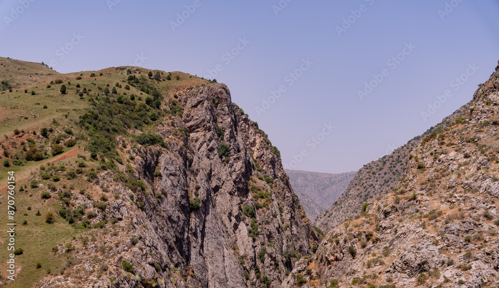 A mountain range with a clear blue sky A mountain range with a clear blue sky