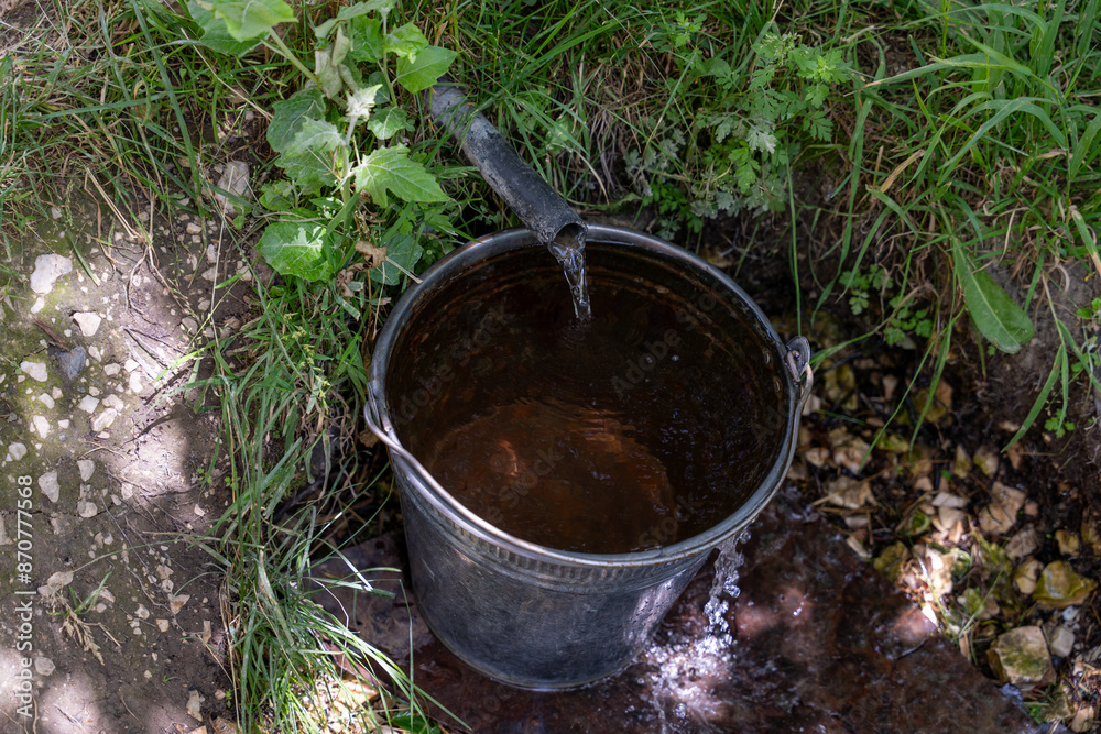 A bucket of water is sitting in a stream A bucket of water is sitting in a stream