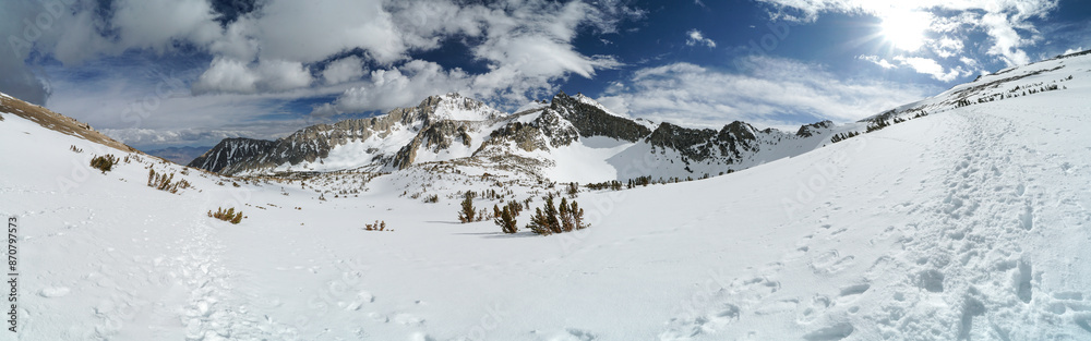 A snow covered mountain range with a clear blue sky A snow covered mountain range with a clear blue sky