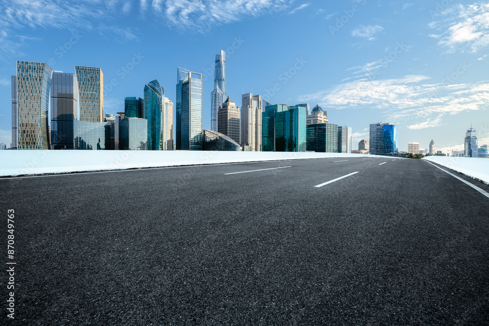 Empty asphalt road and cityscape in modern city Empty asphalt road and cityscape in modern city
