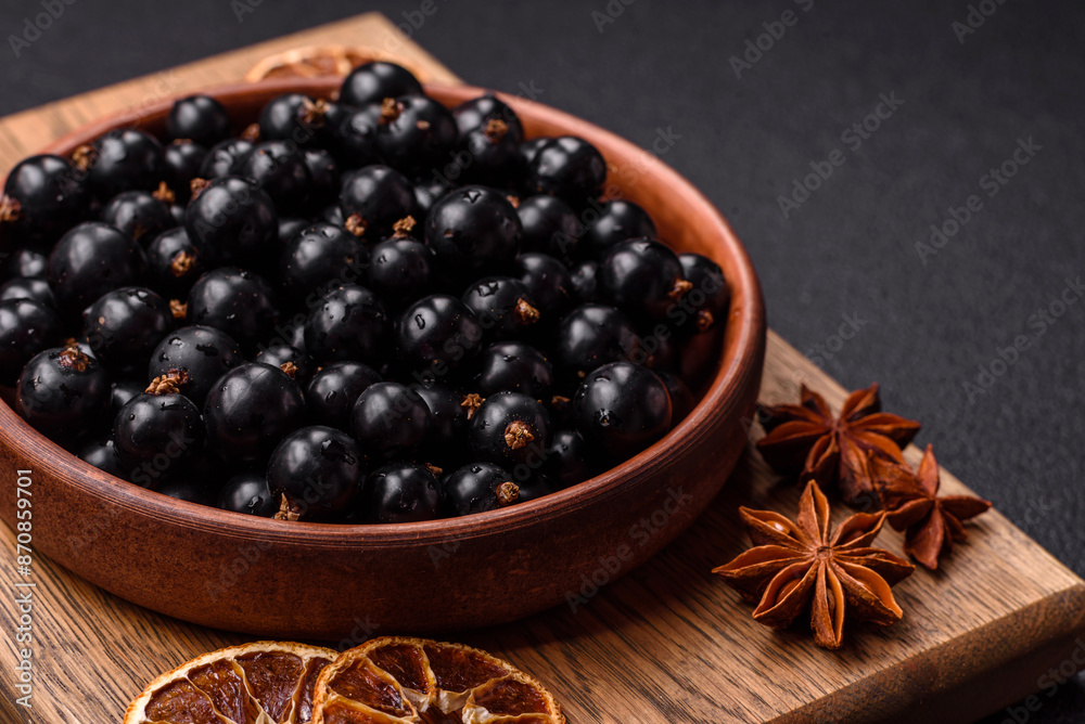 Ripe blackcurrant berries in droplets of water in a ceramic bowl Ripe blackcurrant berries in droplets of water in a ceramic bowl