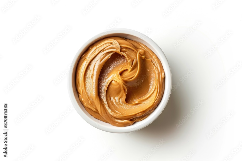 A container filled with creamy peanut butter on a white background A container filled with creamy peanut butter on a white background