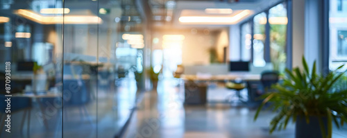 A contemporary office setting with a blurred background of glass partitions, ergonomic workstations, and bright, natural light, creating a clean and professional environment.