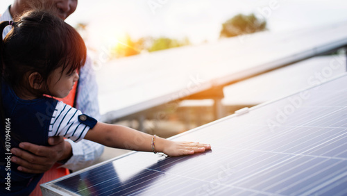 father and daughter by solar panel