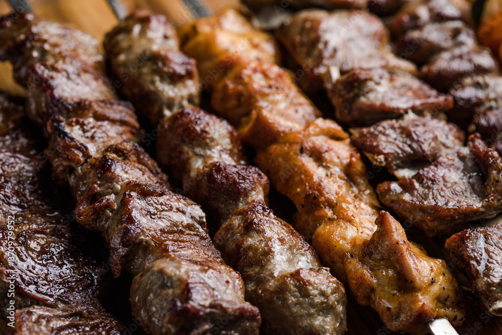 Marinated shashlik preparing on a barbecue grill over charcoal. Shashlyk (skewered meat) was originally made of lamb. Roast Beef Kebabs On BBQ Grill. Marinated shashlik preparing on a barbecue grill over charcoal. Shashlyk (skewered meat) was originally made of lamb. Roast Beef Kebabs On BBQ Grill.