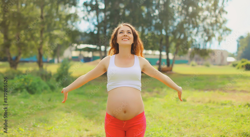 Happy young pregnant woman enjoying warm sunny day in summer park Happy young pregnant woman enjoying warm sunny day in summer park