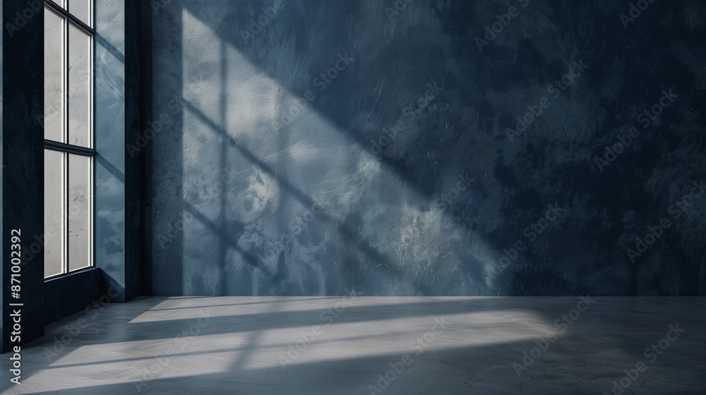 An empty room with a concrete floor and an intensely blue wall creates a modern background with an industrial character. An empty room with a concrete floor and an intensely blue wall creates a modern background with an industrial character.