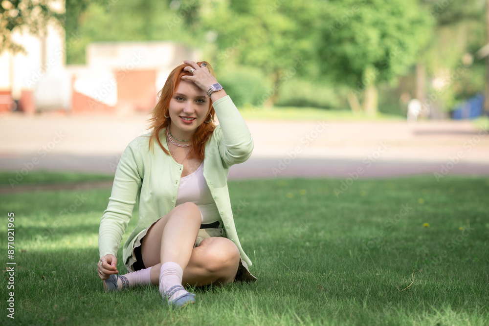 Portrait of a young beautiful red-haired girl in an urban environment. Portrait of a young beautiful red-haired girl in an urban environment.