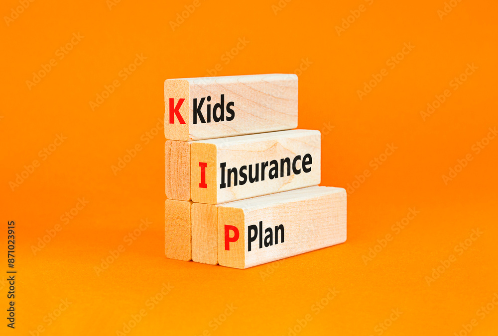 Naklejka premium KIP kids insurance plan symbol. Concept words KIP kids insurance plan on beautiful wooden blocks. Beautiful orange background. Business KIP kids insurance plan concept. Copy space.