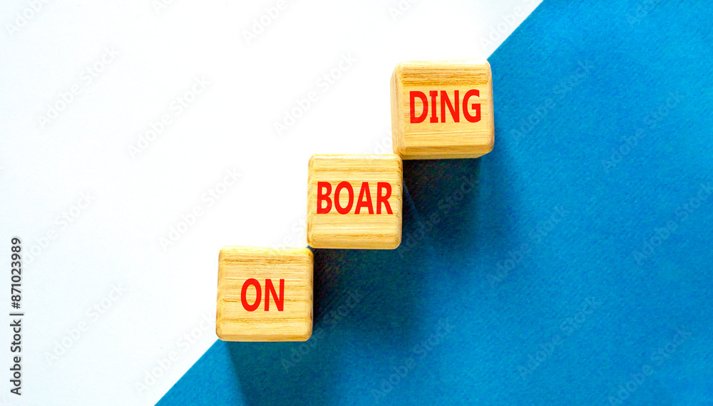 Obraz premium Onboarding success symbol. Concept word Onboarding on wooden blocks. Beautiful blue and white background. Business onboarding success concept. Copy space.