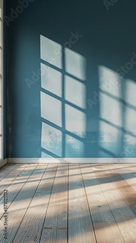Sunlight casting window shadows on blue wall and wooden floor