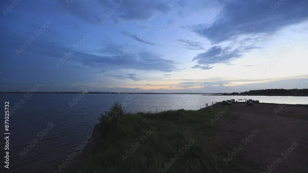 video background 4K of the morning sun rising in the middle of the sea, small fishing boats and many kinds of birds flying past in blur, the beauty of seaside community life.