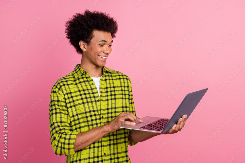 Photo of nice young man use laptop wear shirt isolated on pink color background