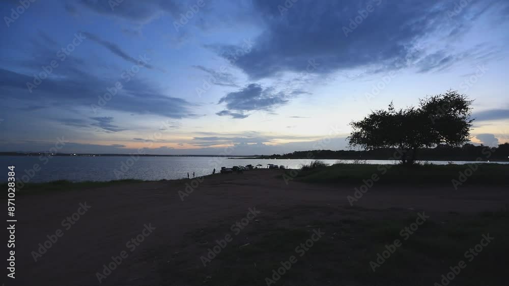 video background 4K of the morning sun rising in the middle of the sea, small fishing boats and many kinds of birds flying past in blur, the beauty of seaside community life.