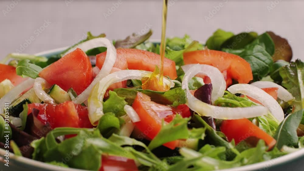 Pouring olive oil on healthy fresh vegetables vegan salad, close up, Delicious diet salad of tomato, green onion, greens and olive oil, healthy meal and mediterranean kitchen