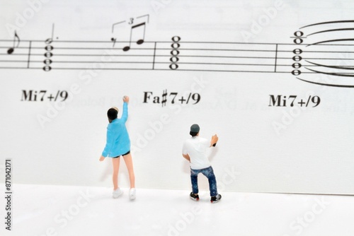 miniature figurines of a couple of writers painting an empty urban wall