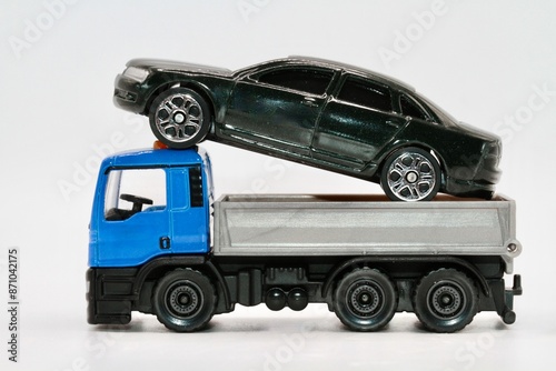 a toy truck transporting a car