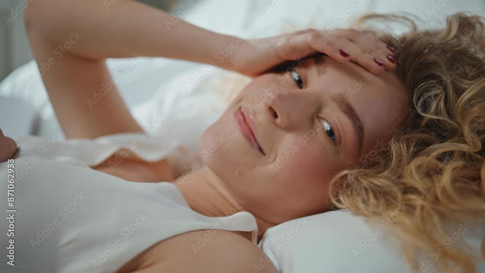 Girl resting tranquil morning in home bedroom. Closeup smiling model lying Girl resting tranquil morning in home bedroom. Closeup smiling model lying