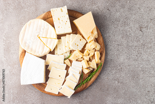 Wooden board with various cheese and olives. Brie. Camembert. Parmesan, feta, blue cheese. Italian, French cheese. photo