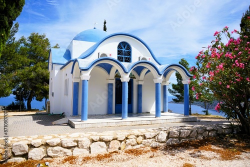 Beautiful view of Agia Kyriaki church with its blue roof and white walls on a hill with sea view in Tolo in Greece photo