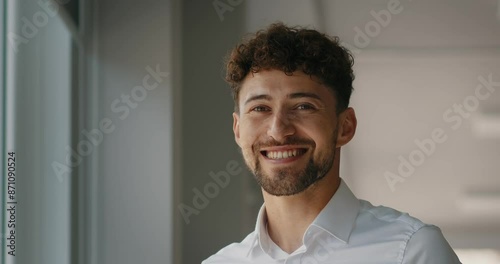 Dreaming caucasian handsome young man agent worker deep in thoughts look away turn head at camera happy male human face friendly businessman, guy smiling with toothy smile.